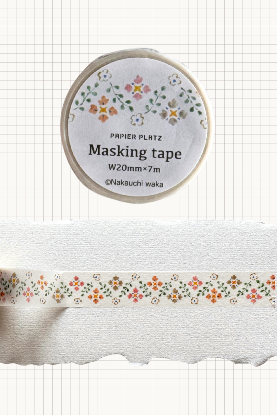 Papier Platz floral masking tape roll with delicate hand painted rows of tiny orange pink and white flowers, shown on grid background with a swatch of the 20 mm wide tape unrolled