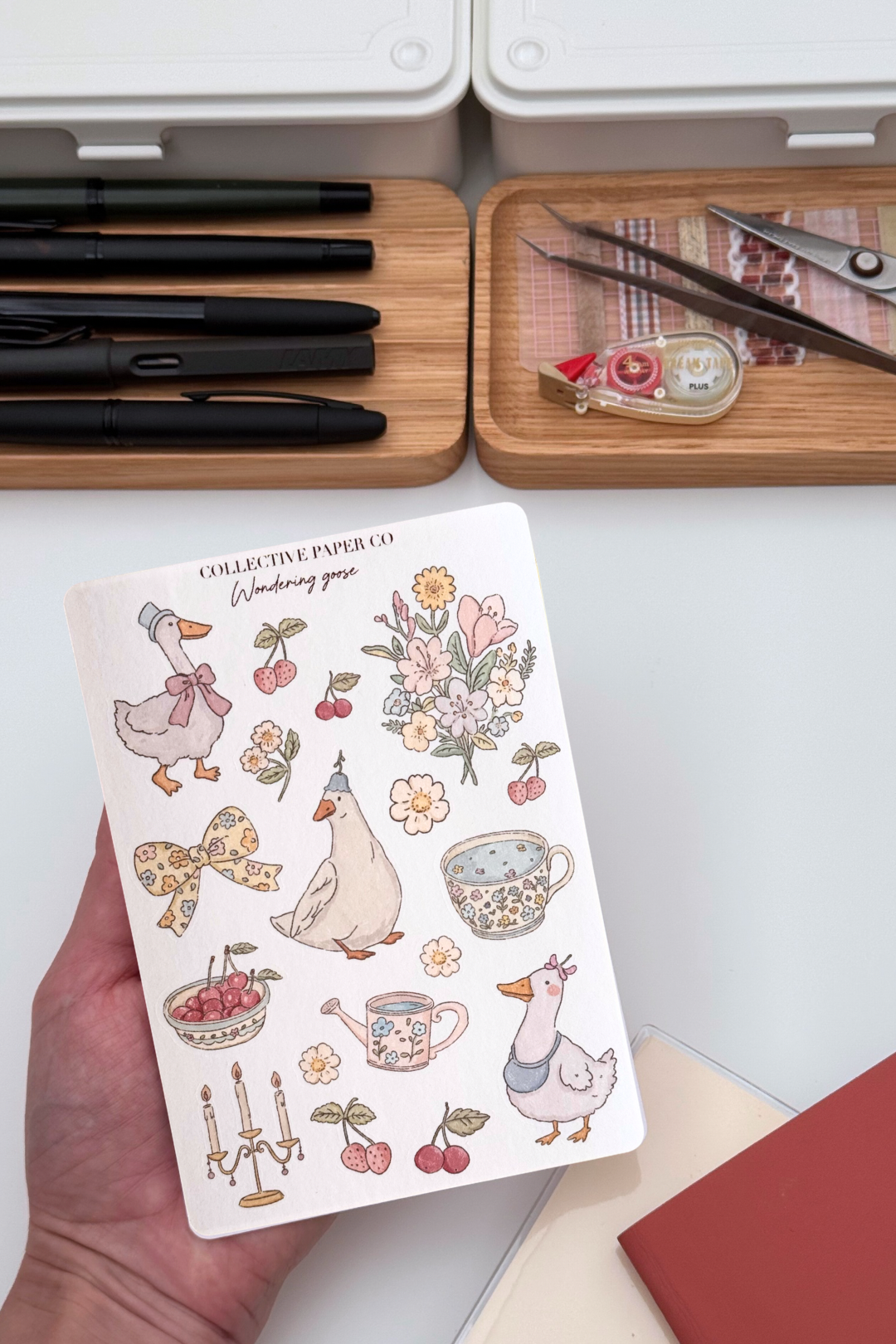 Wondering goose sticker sheet with pastel crayon style illustrations of geese, floral bouquets, bows, cherries, strawberries, floral teacups and a candelabra from Collective Paper Co