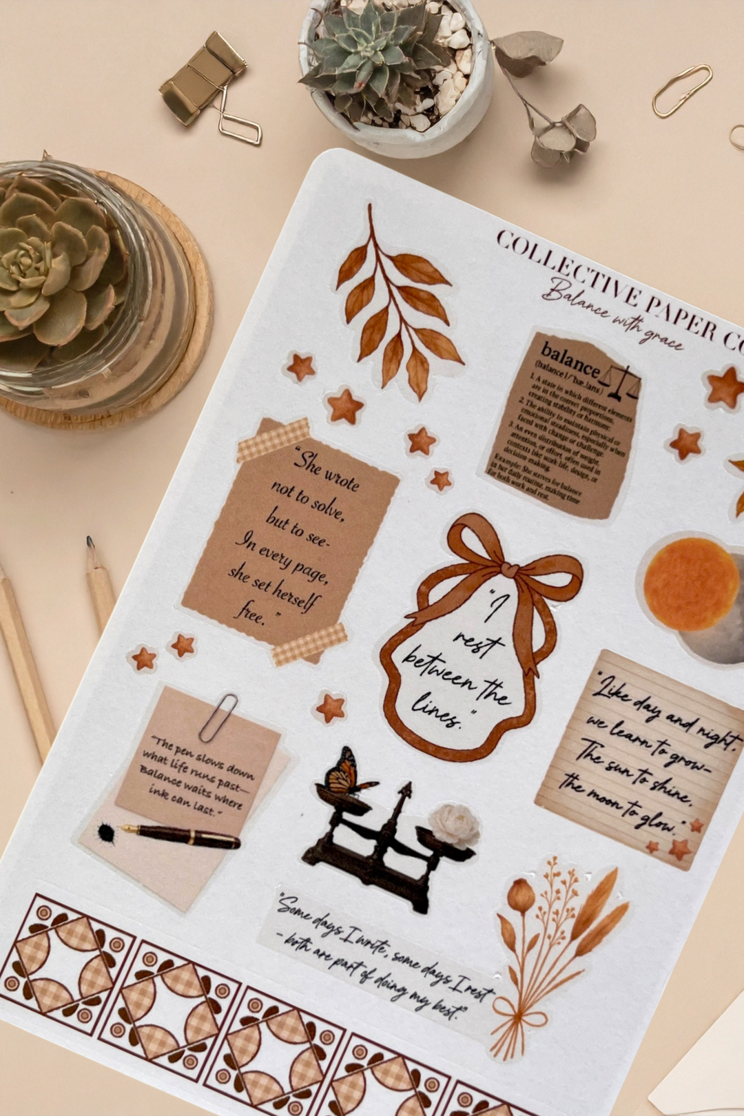 Sheet of decorative stickers with text and illustrations on a beige surface with plants and stationery items.