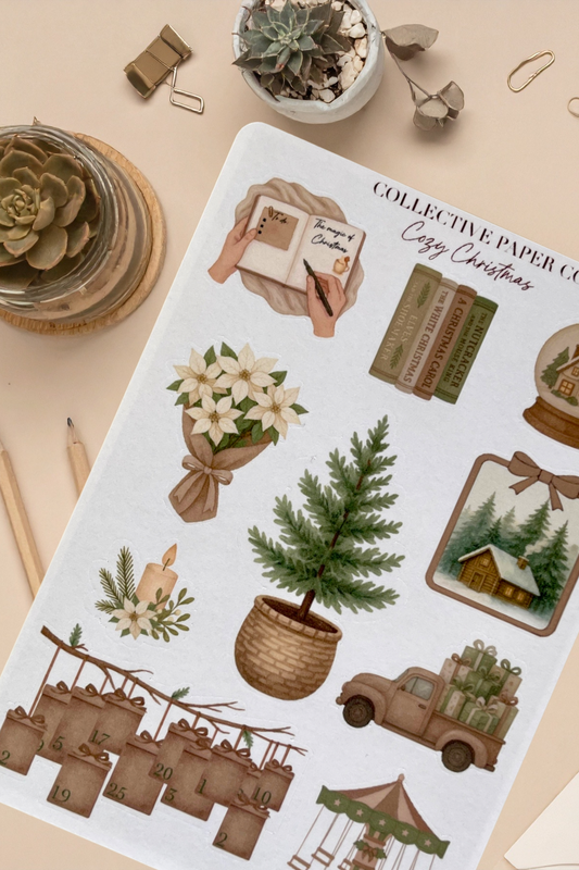 Sheet of Christmas-themed stickers with trees, houses, and other festive elements on a beige surface.