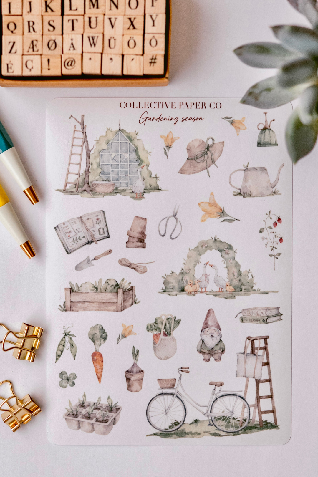 Collective Paper Co.'s Gardening Season washi tape illustrates watercolor greenhouses, watering cans, hats, tools, arches, vegetables like carrots and peas, gnomes, ducks, bikes, and ladders.
