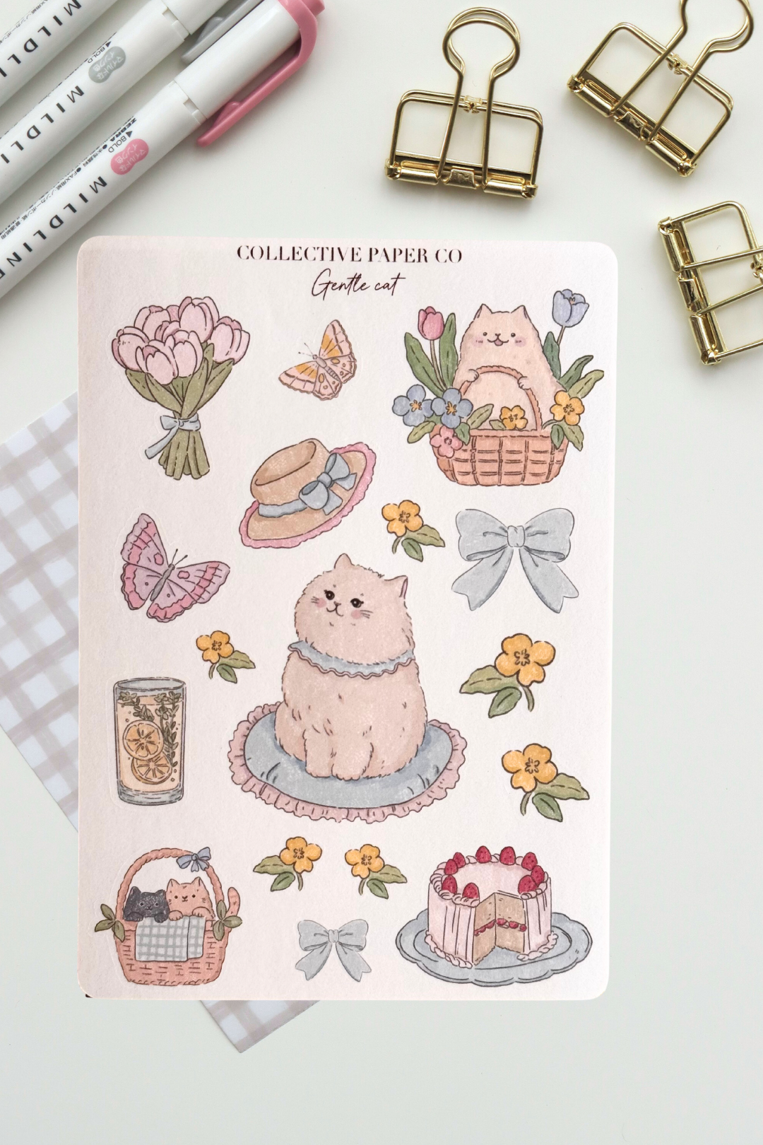 Gentle cat sticker sheet with soft crayon style illustrations of a fluffy cat, flower baskets, bouquet, butterflies, bows, citrus drink and strawberry cake in pastel spring colours from Collective Paper Co