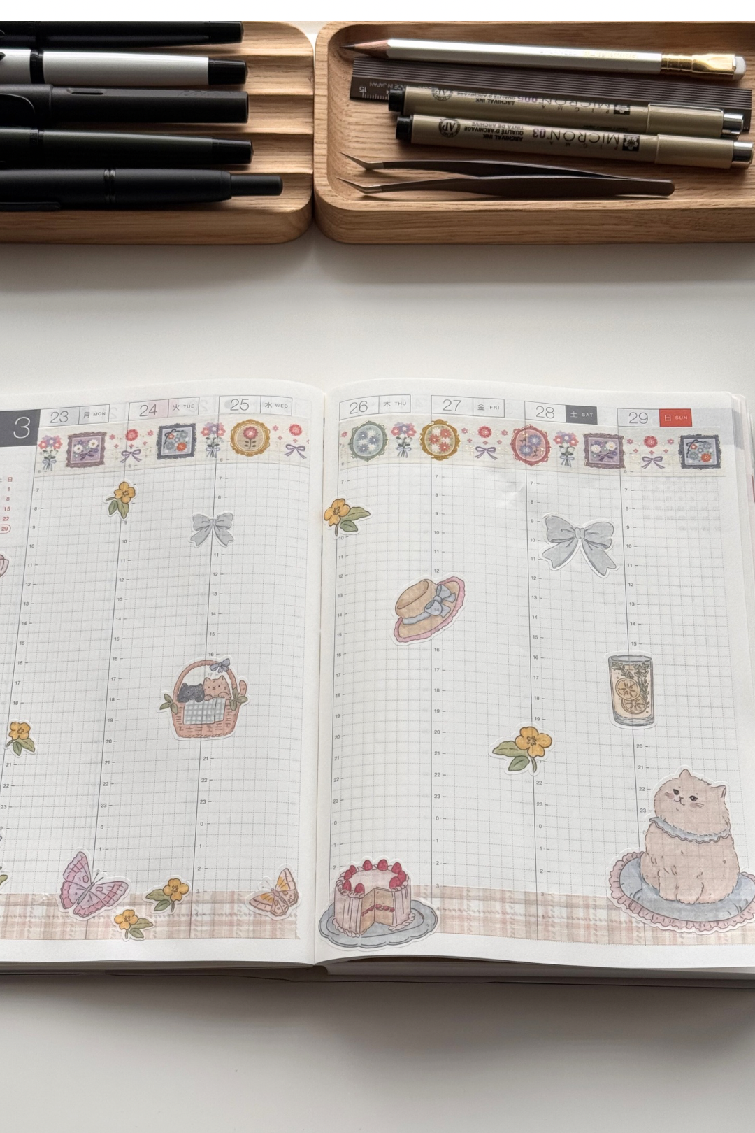 Gentle cat sticker sheet with soft crayon style illustrations of a fluffy cat, flower baskets, bouquet, butterflies, bows, citrus drink and strawberry cake in pastel spring colours from Collective Paper Co