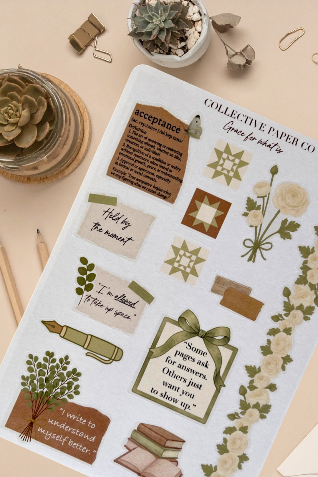 Sheet of decorative stickers with motivational phrases and illustrations on a beige surface.