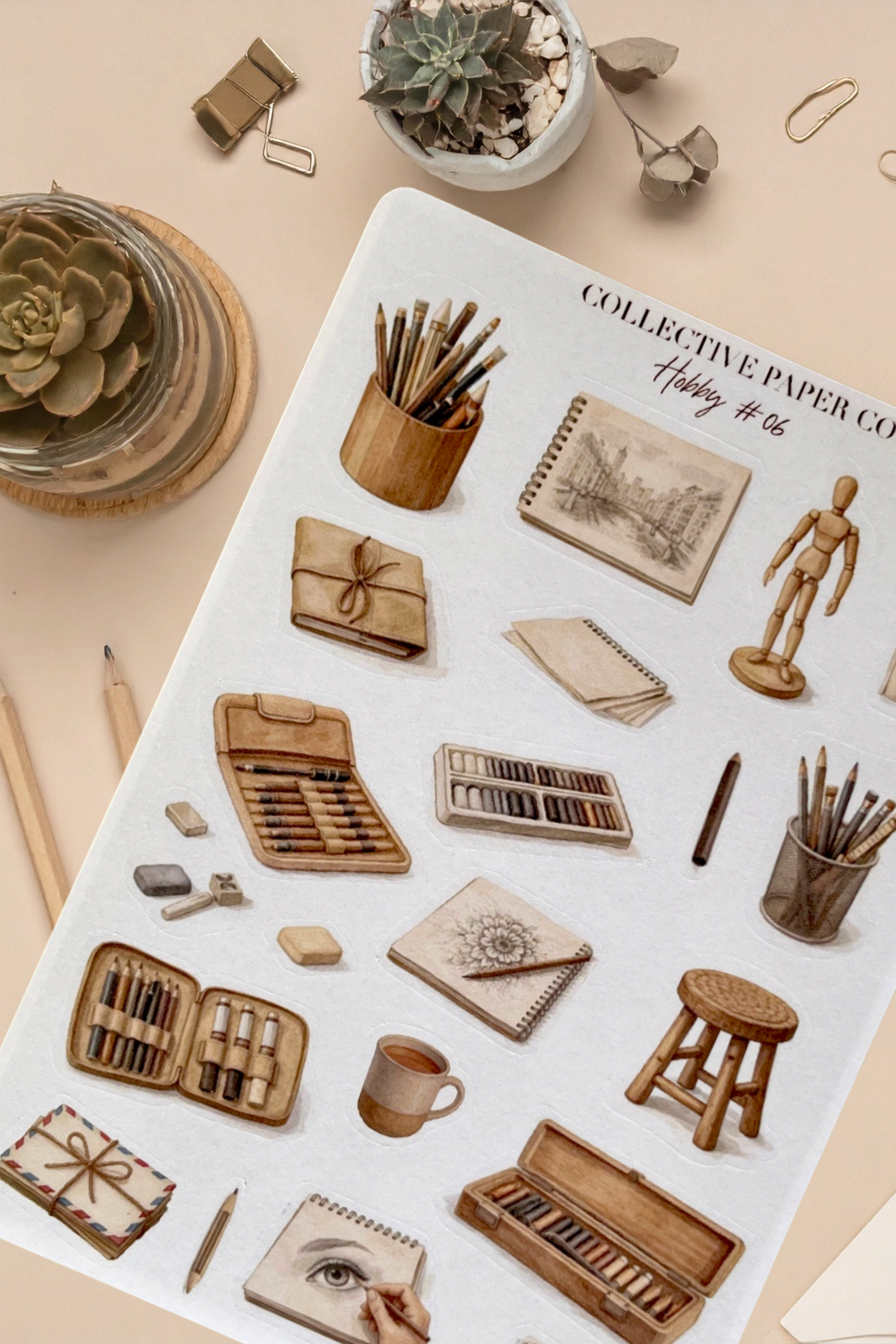 Stationery items including notebooks, pencils, and a small plant on a beige surface.