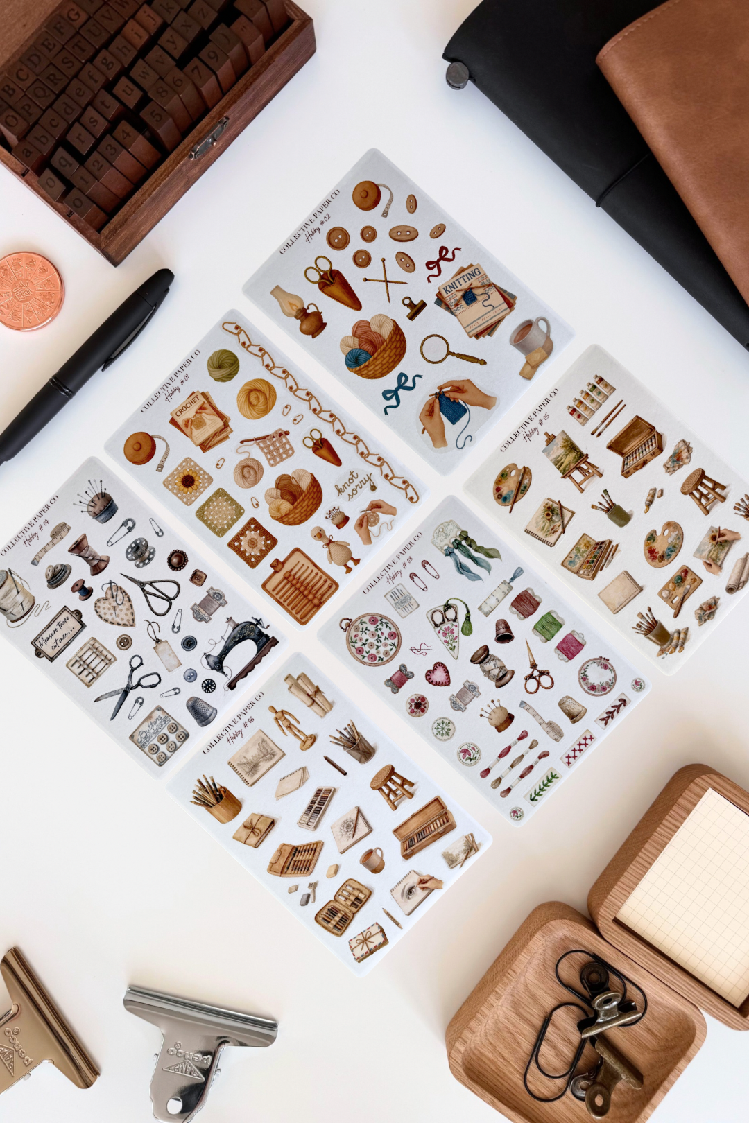 Set of decorative stamps on a white surface with a wooden box and other items.