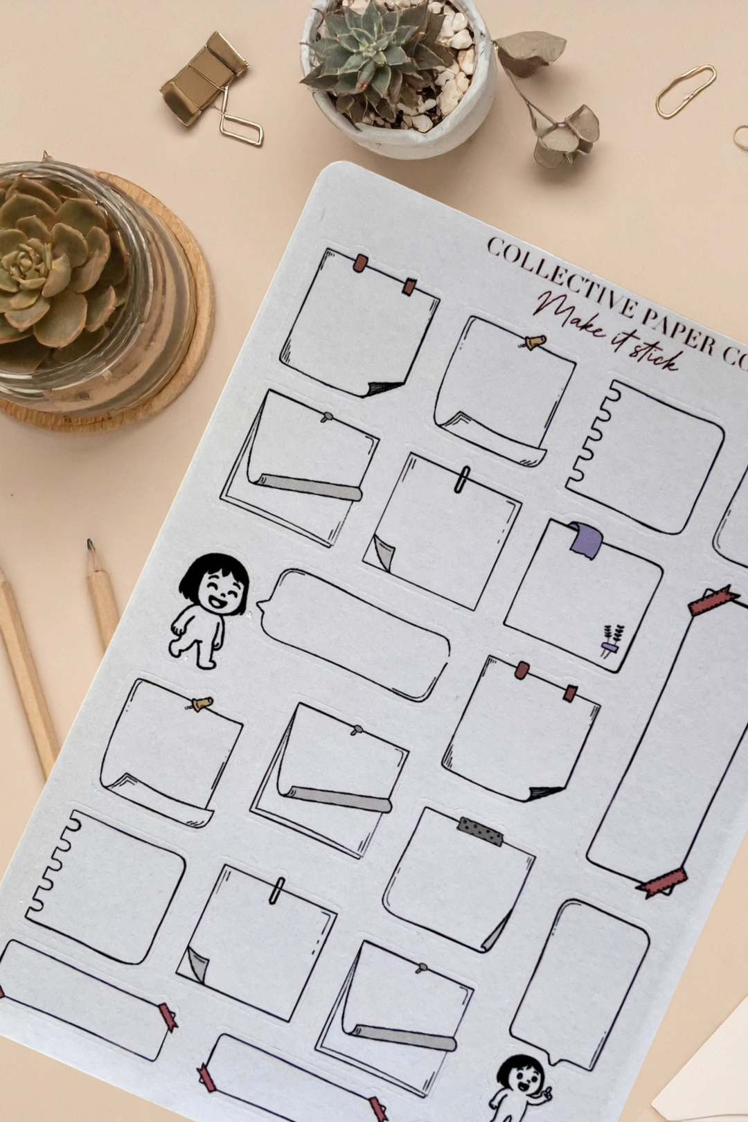 Notebook with planner stickers on a desk with office supplies