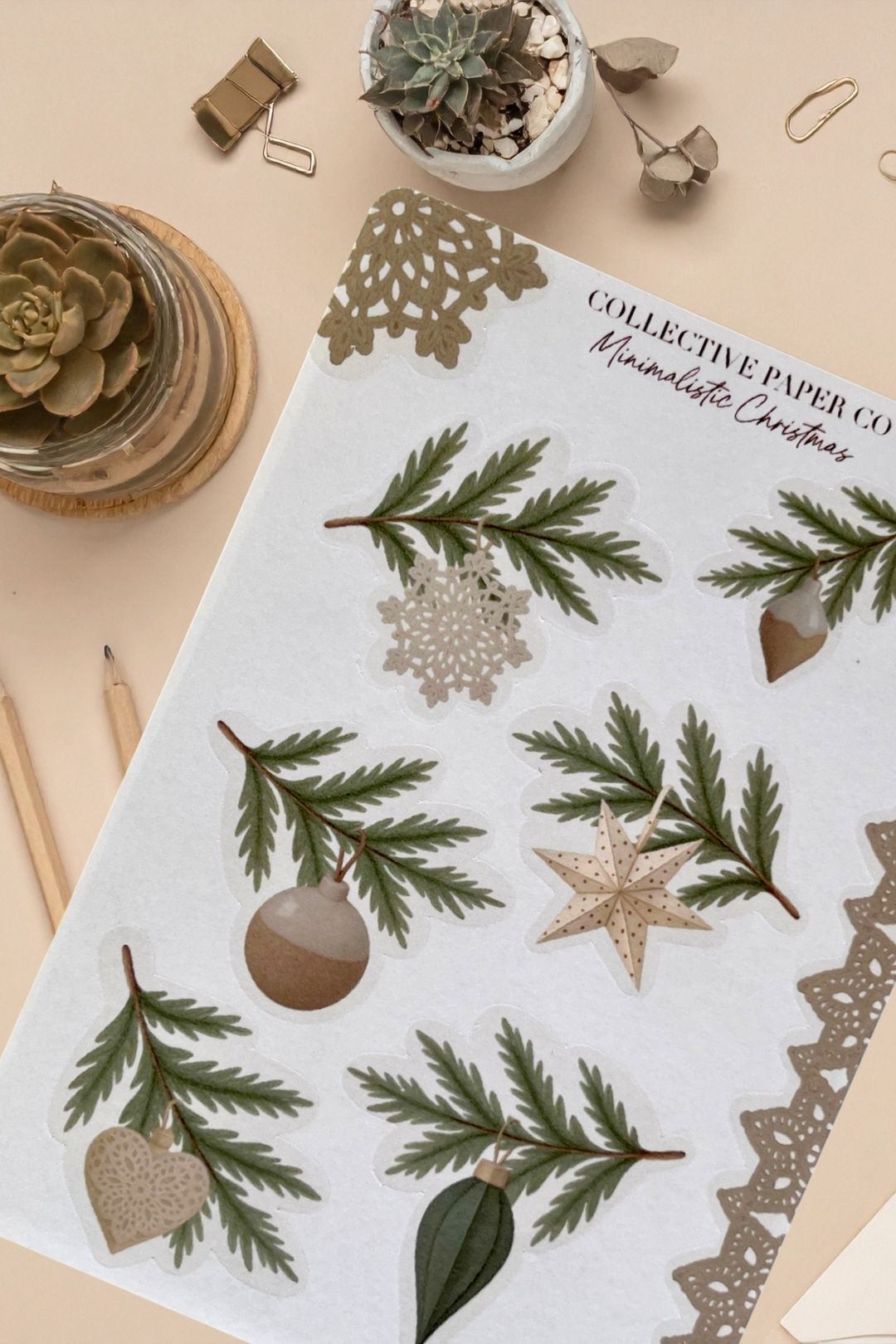 Sheet of decorative paper with Christmas designs on a beige surface.