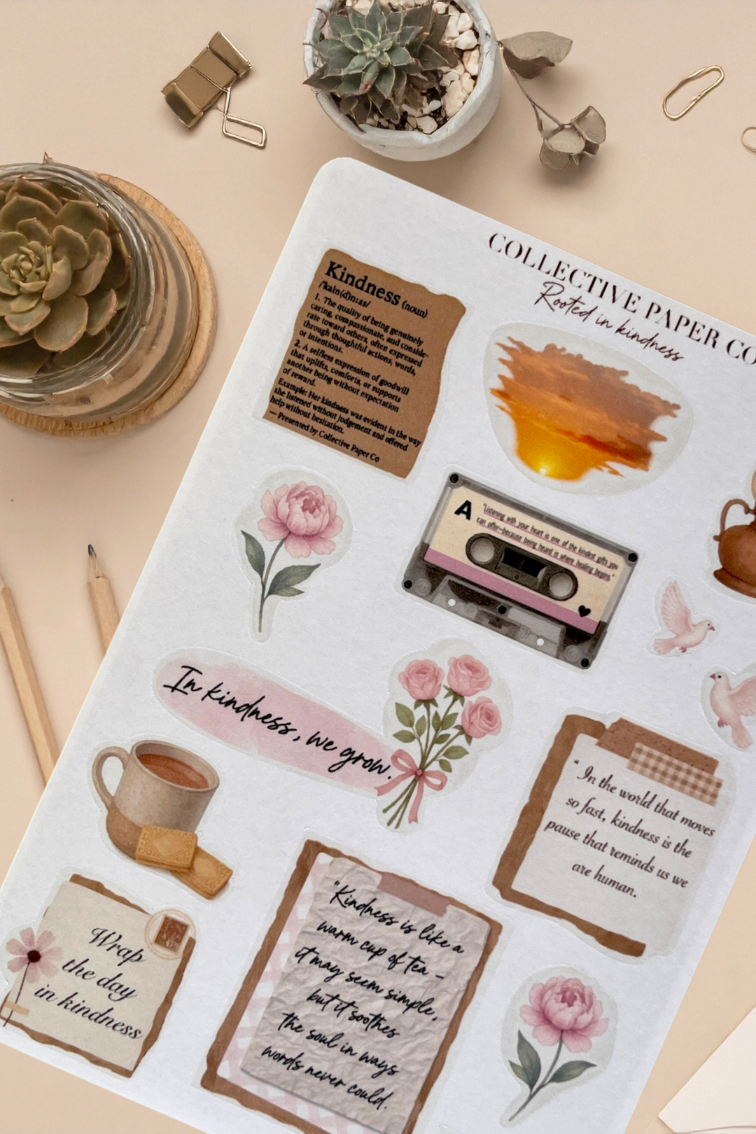 Sheet of decorative stickers with motivational phrases, flowers, and a cassette tape on a beige background.