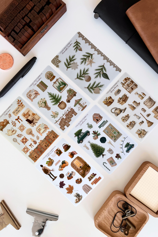 Set of decorative stamps on a white surface with a pen and other items.
