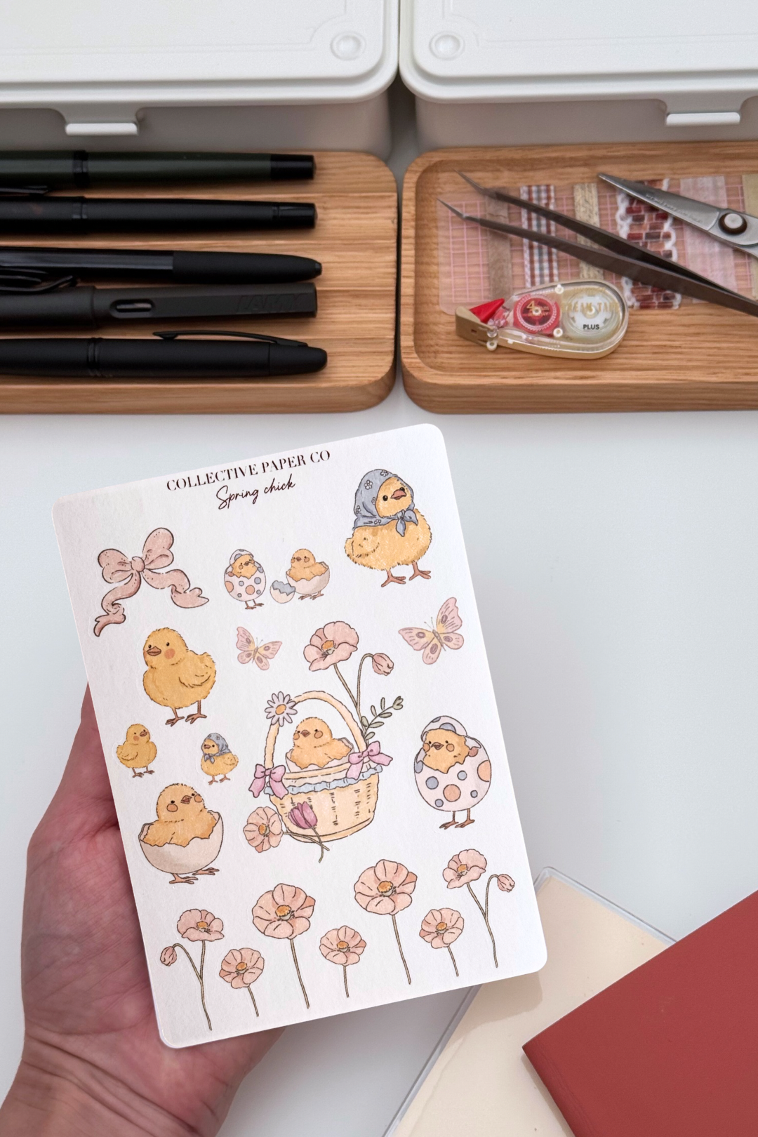 Spring chick sticker sheet with pastel crayon style illustrations of chicks, bows, flowers, butterflies, eggshells and a floral basket border in soft spring colours from Collective Paper Co