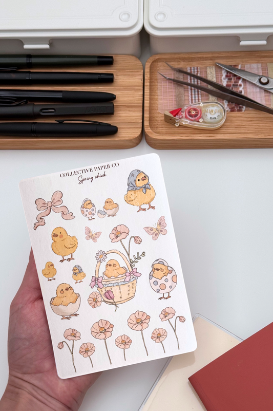 Spring chick sticker sheet with pastel crayon style illustrations of chicks, bows, flowers, butterflies, eggshells and a floral basket border in soft spring colours from Collective Paper Co