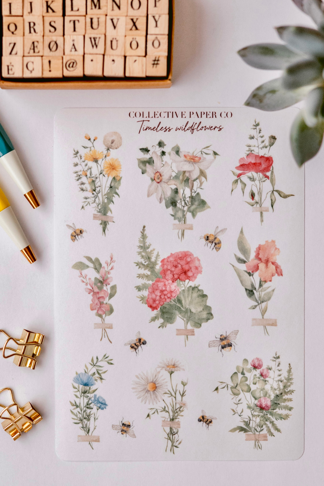 Collective Paper Co.'s Timeless Wildflowers washi tape displays watercolor bouquets of yellow daisies, white lilies, red poppies, pink peonies, ferns, butterflies, and bees with tape accents.