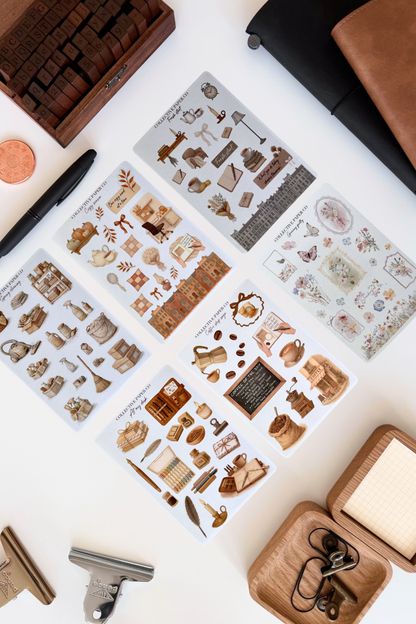 Collection of decorative stickers with vintage-style illustrations on a white surface.